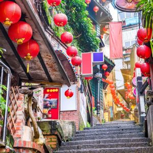 Narrow stone stairway decorated with red lanterns and shops