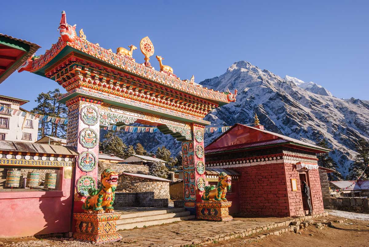 Colorful Nepalese gateway with snowy Himalayan mountains in background