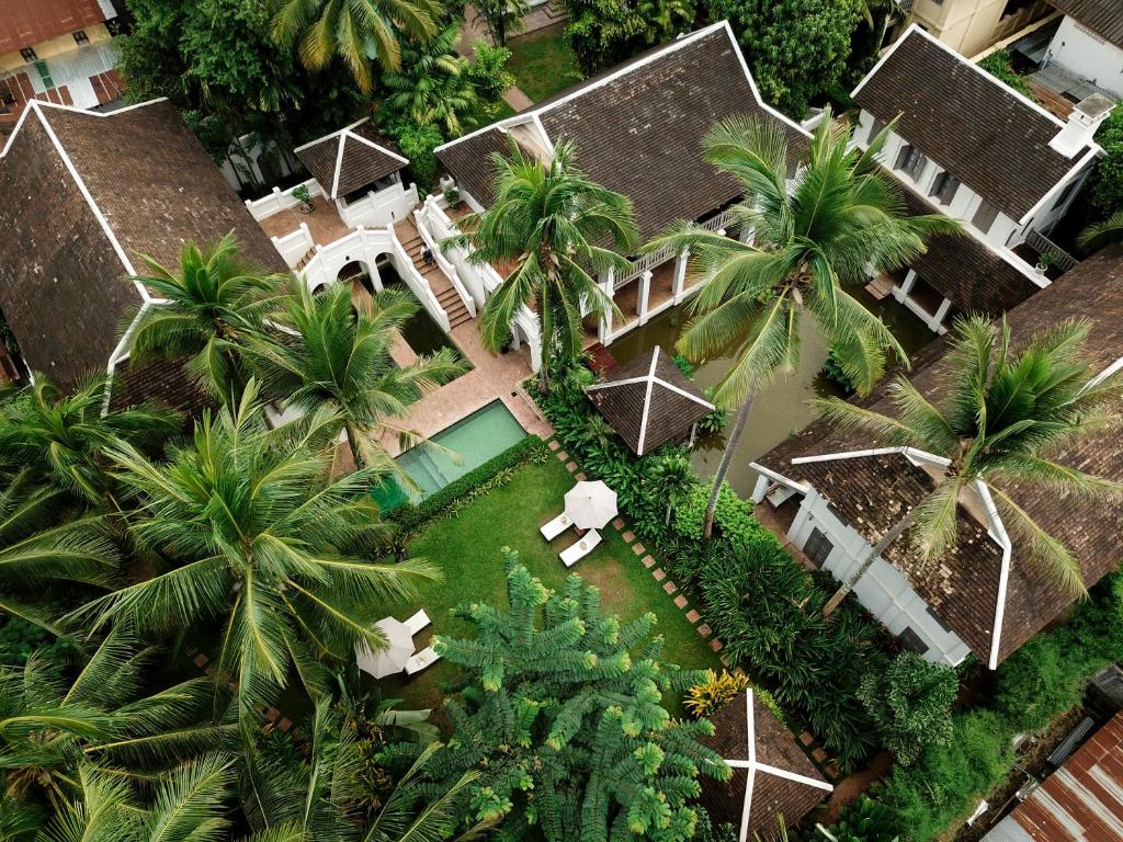 Aerial view of Satri House with central pool and tropical palm trees