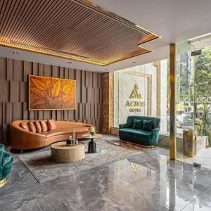 Modern hotel lobby seating with curved leather sofa and green chairs