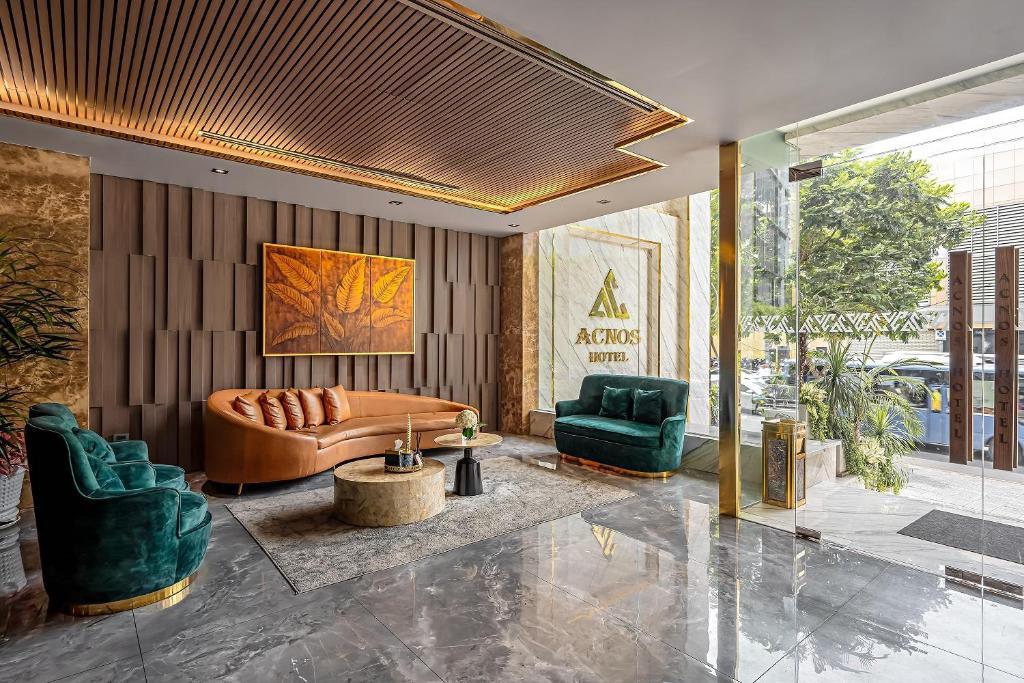 Modern hotel lobby seating with curved leather sofa and green chairs