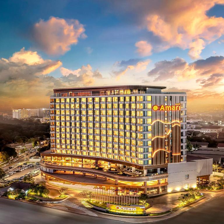 Amari Vientiane Hotel illuminated at sunset in city setting