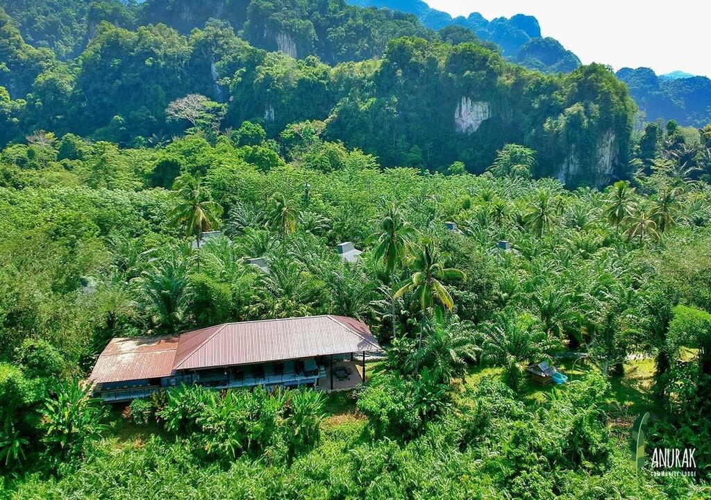 Community lodge surrounded by dense jungle and limestone mountains