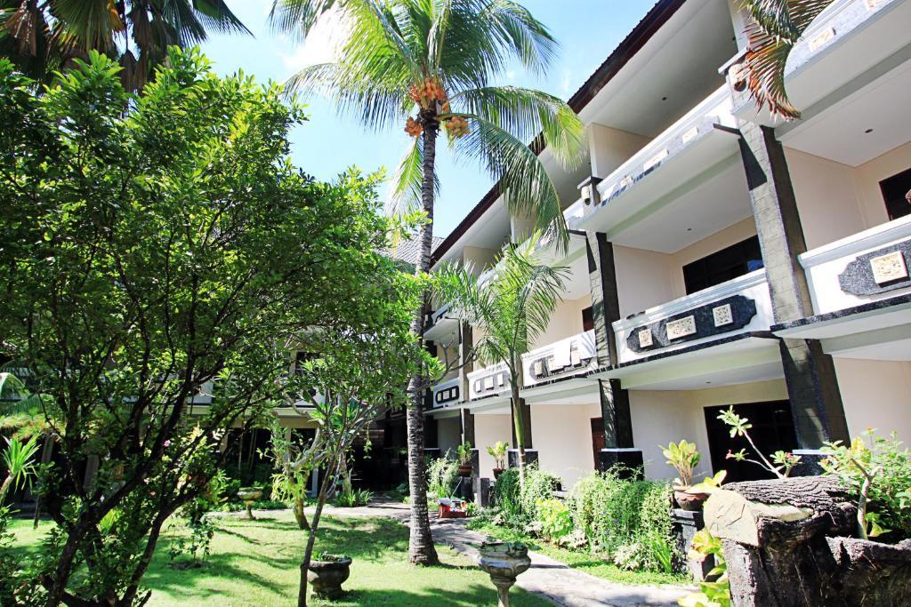 Bakung Beach Resort courtyard with palm trees and green plants