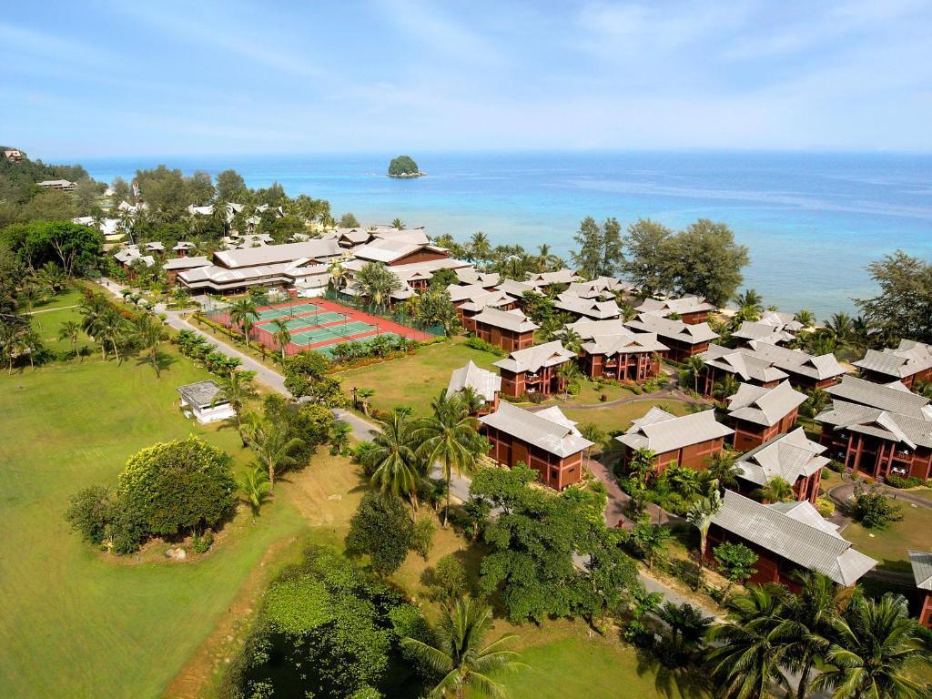 Aerial view of Berjaya Tioman Resort with beachfront villas, tennis courts and tropical vegetation