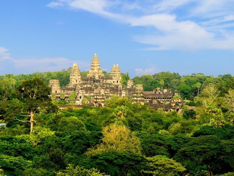 Angkor Wat temple rising above green jungle in Siem Reap, Cambodia