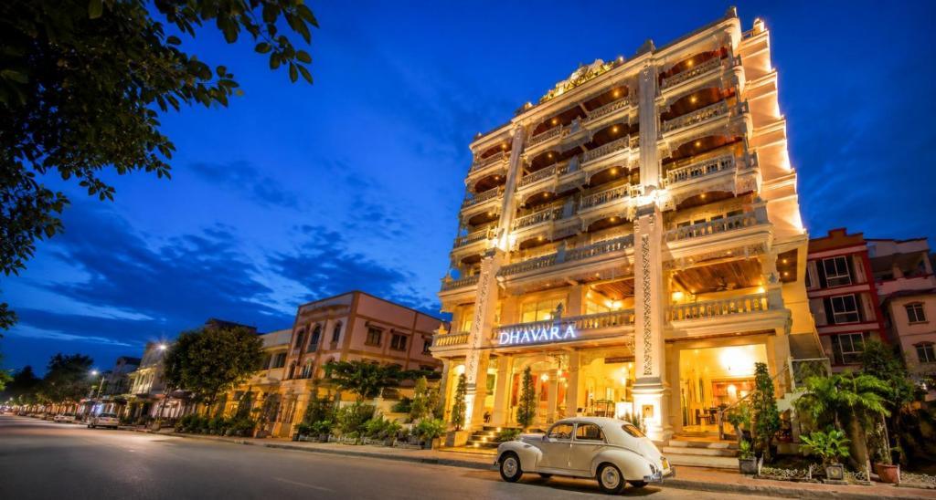 Dhavara Boutique Hotel exterior lit up at night with a classic car parked outside