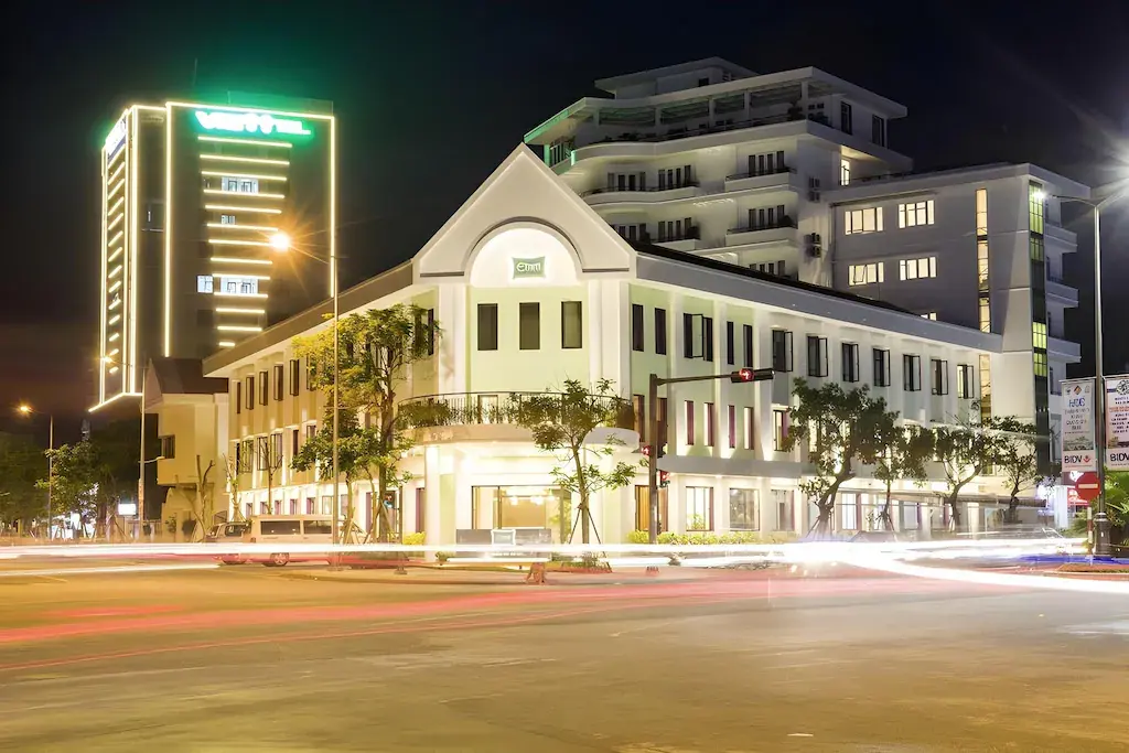 Emm Hotel Hue exterior at night with light trails on city street