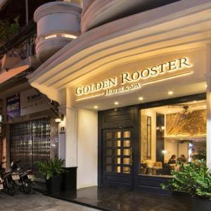 Golden Rooster Hotel & Spa entrance lit up at night with seating area inside