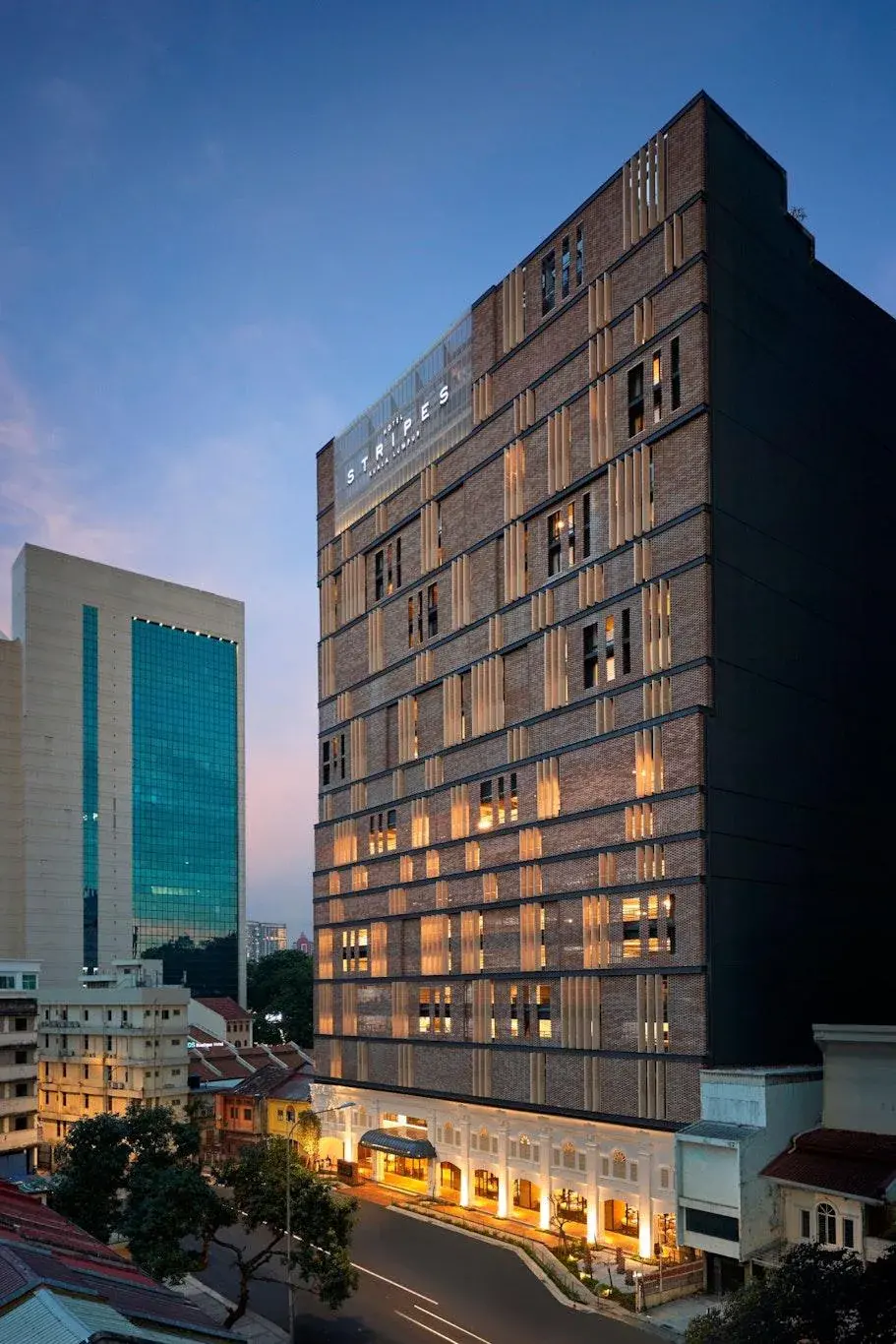 Hotel Stripes Kuala Lumpur building illuminated at dusk in urban cityscape