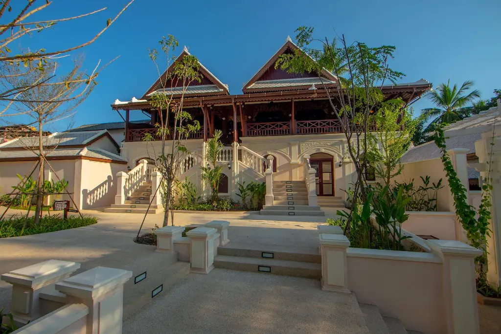Exterior courtyard and façade of Le Bel Air Resort with stairs and tropical plants