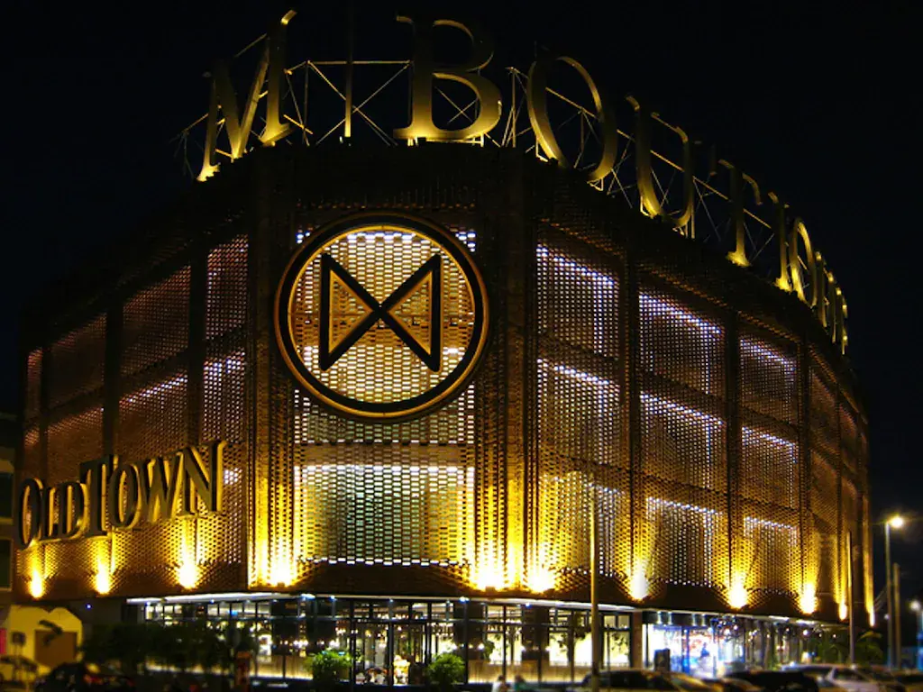 Nighttime view of M Boutique Ipoh building with illuminated gold lights and signage