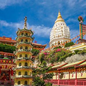 Kek Lok Si Buddhist temple complex with pagoda and white tower under blue sky