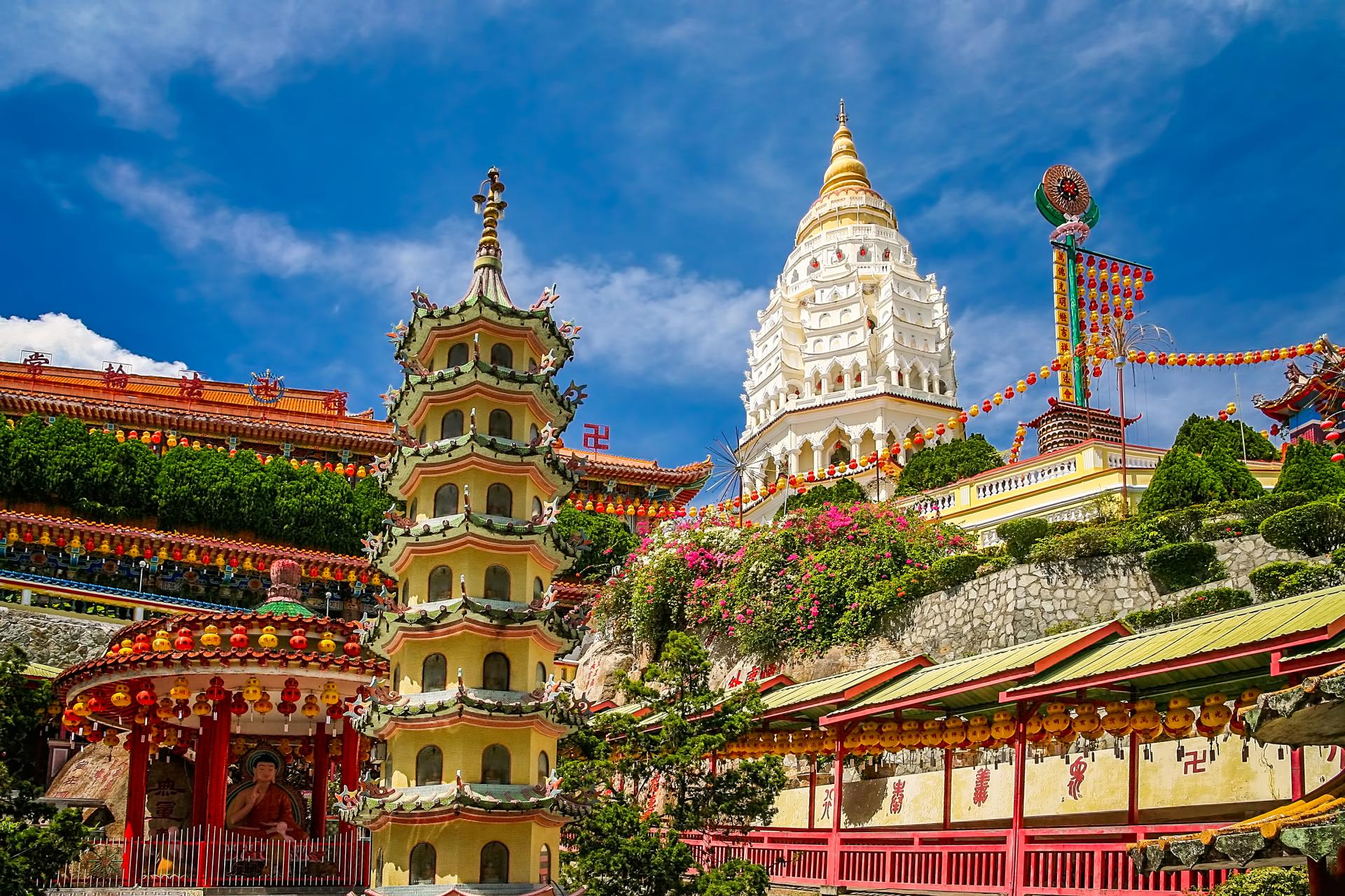 Kek Lok Si Buddhist temple complex with pagoda and white tower under blue sky