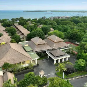 Aerial view of Mercure Sanur resort surrounded by trees with ocean in background