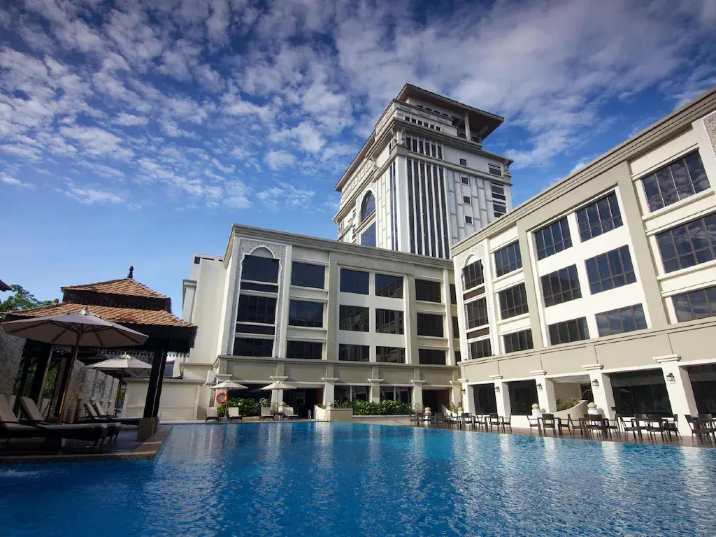 Perdana Kota Bharu hotel exterior with outdoor swimming pool and lounge area