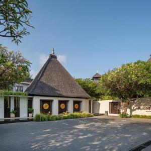 Entrance of Ramayana Suites & Resort with traditional peaked roofs and greenery