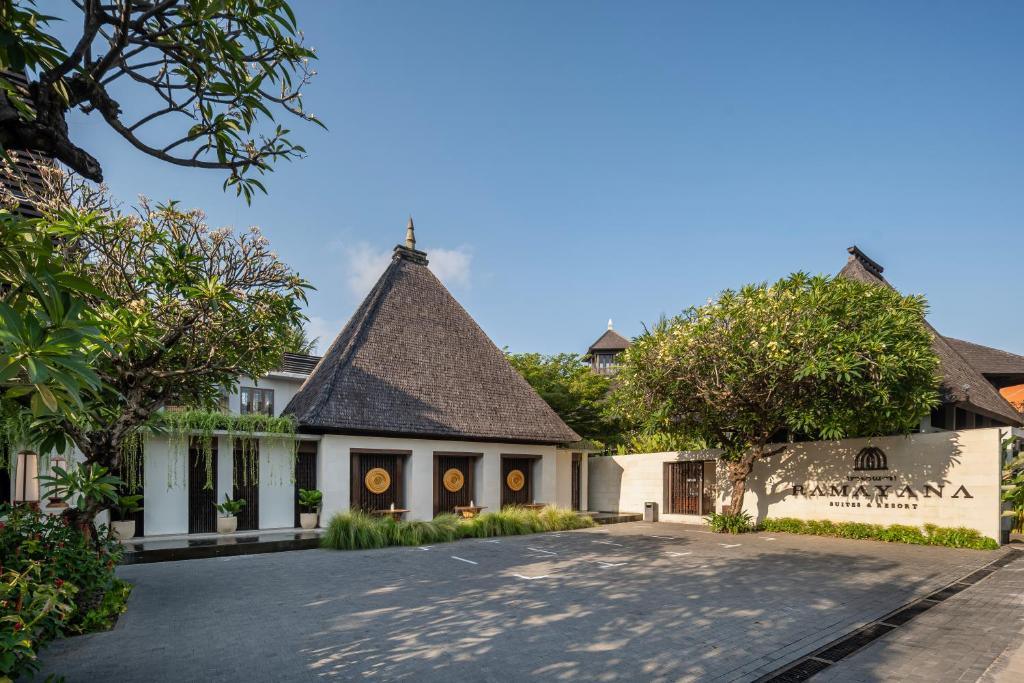 Entrance of Ramayana Suites & Resort with traditional peaked roofs and greenery