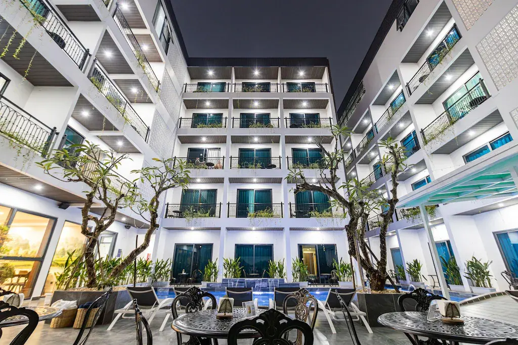 Night view of The Green Hotel Vientiane courtyard with pool and outdoor seating