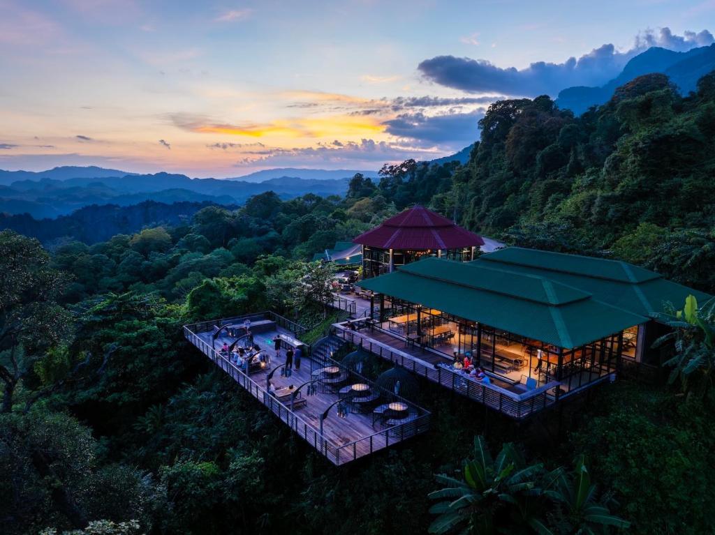 The Rock Lodge resort with terraces overlooking green mountains at sunset