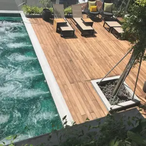 Outdoor Jacuzzi pool with wooden deck and lounge chairs