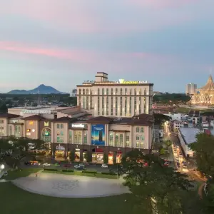 Evening city view of The Waterfront Hotel and a cultural building with unique architecture