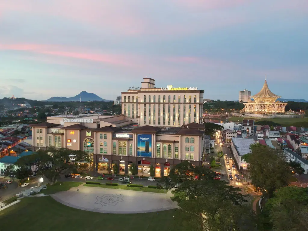 Evening city view of The Waterfront Hotel and a cultural building with unique architecture