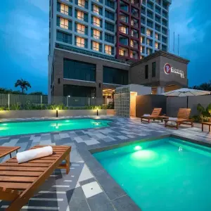 Travelodge hotel outdoor pools with lounge chairs at dusk