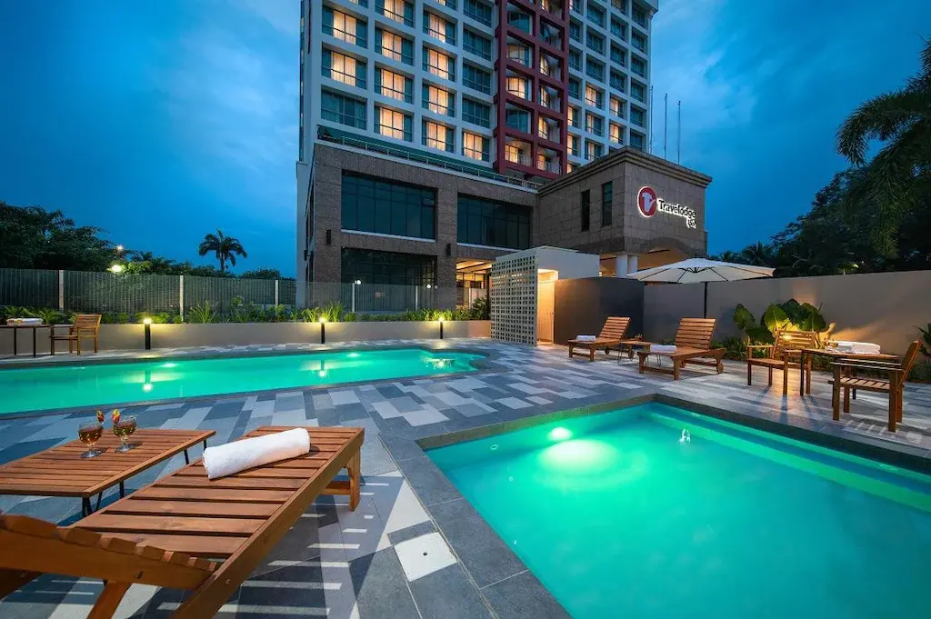 Travelodge hotel outdoor pools with lounge chairs at dusk